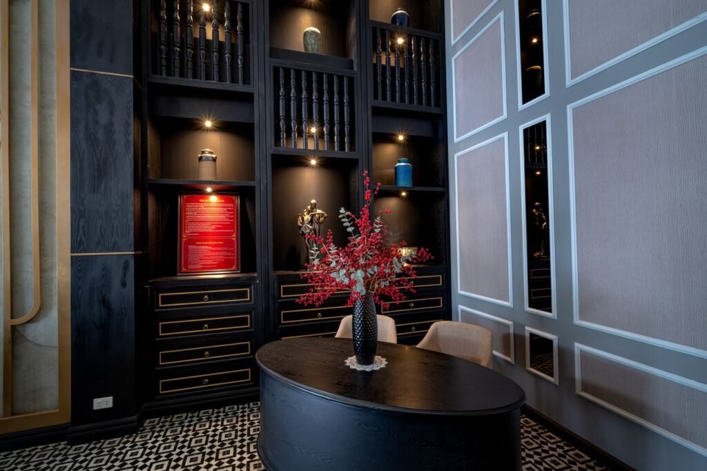 Luxurious interior with modern design featuring a vase with red flowers on an elegant desk.